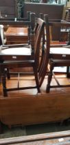 A walnut drop leaf table and four 1930s oak chairs.