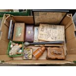 A box of assorted collectables including a treen bottle holder, a carved wood casket, war time