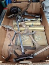 A box of assorted metalware to include cast fire dogs & brass items etc.
