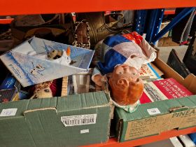 Two boxes comprising railway books, a composition doll and meerkat toys.