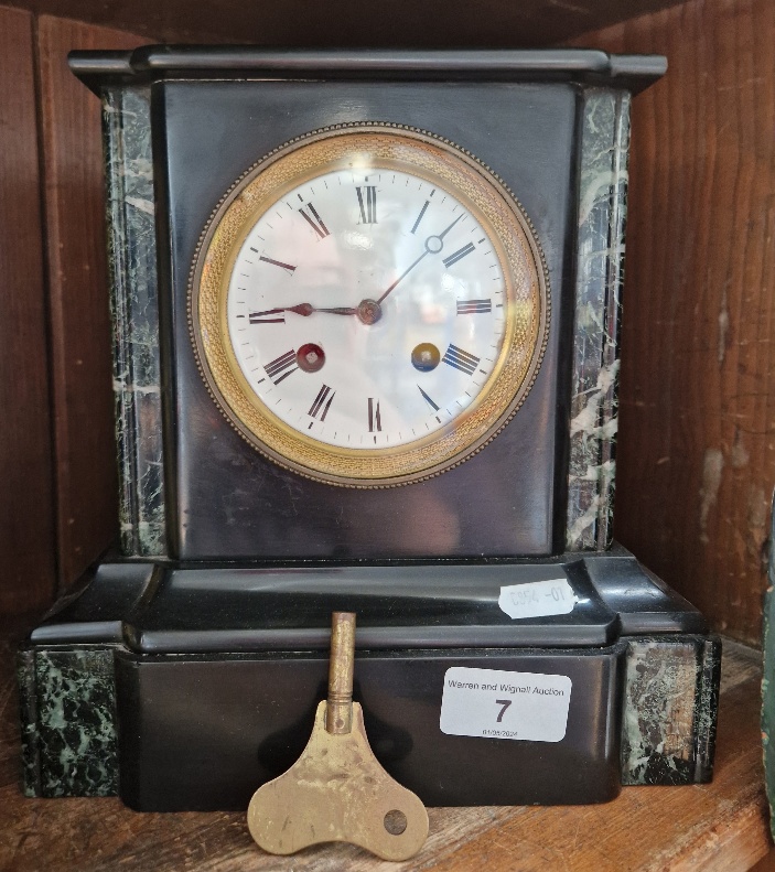 A black slate mantle clock.