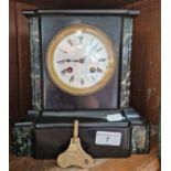 A black slate mantle clock.
