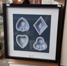 A framed display of blue and white Wedgwood jasperware.