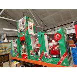 A group of five animated Father Christmas models