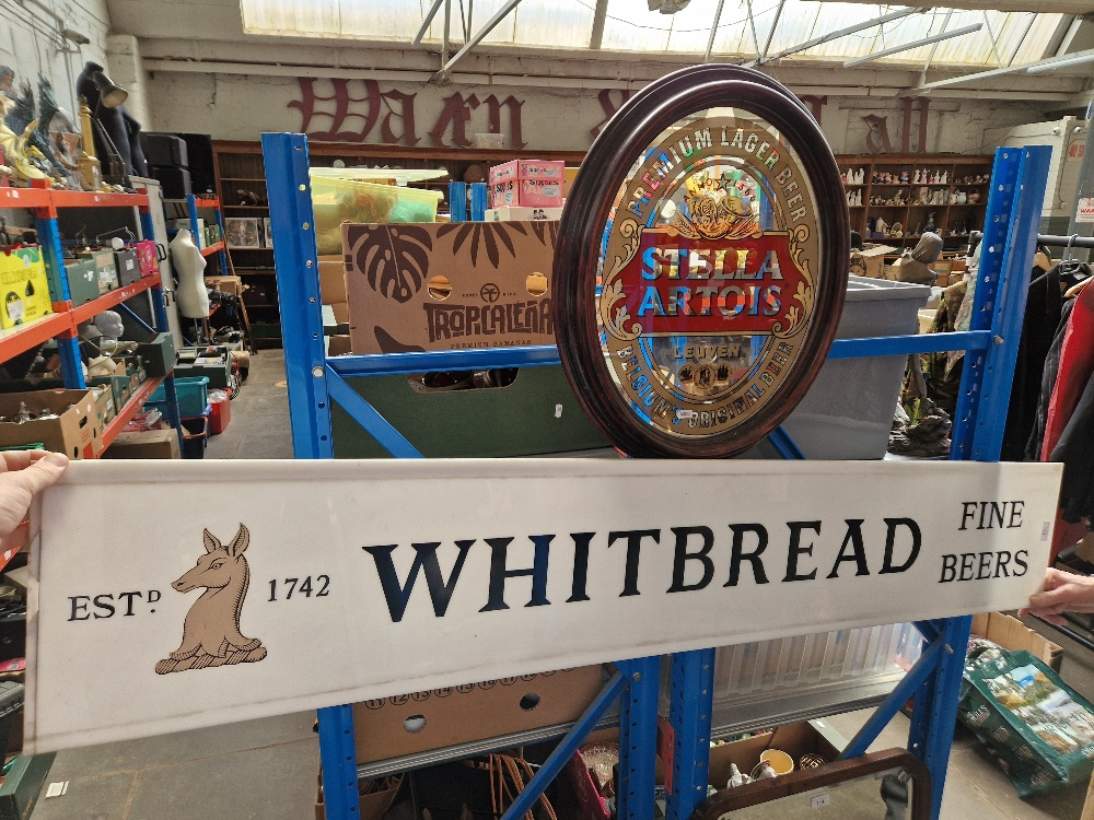 A large Whitbread fine beers sign & a Stella Artois mirror
