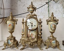 A German mantle clock and garnitures.