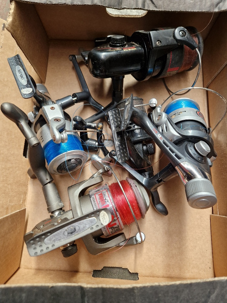 A box of coarse fishing reels, five in total.