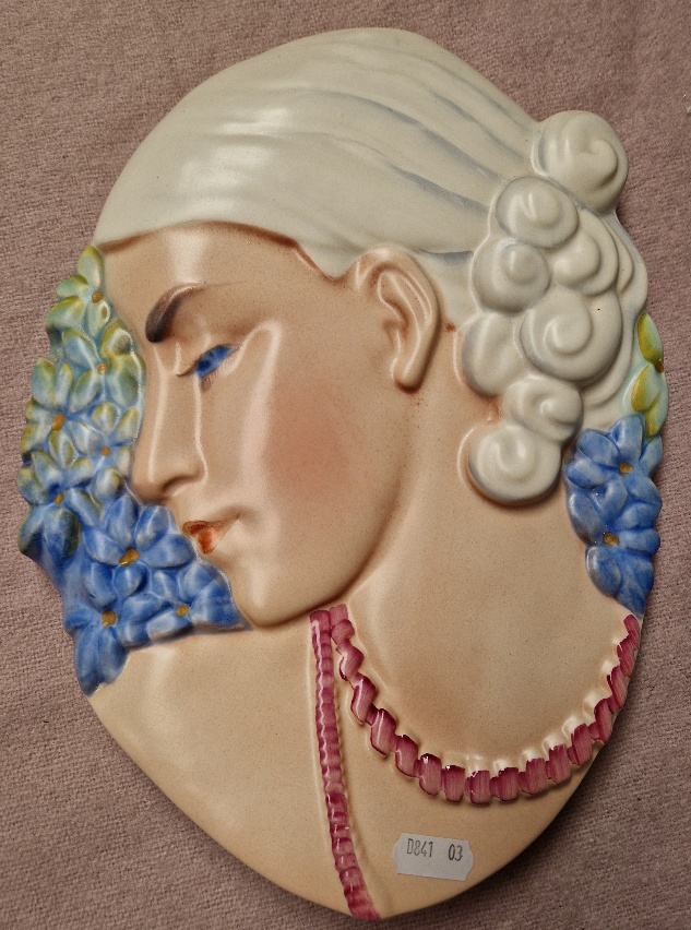 A 1930s Art Deco pottery wall mask.
