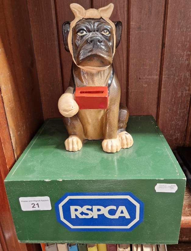 A vintage RSPCA collection box.