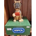 A vintage RSPCA collection box.