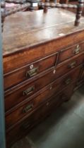 A George III oak chest of drawers, later handles.