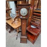 A 1920s oak cased granddaughter clock by Waring and Gillow with presentation plaque for 1925.