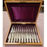 A cased set of knives and forks, 12 settings, mother of pearl handles, box marked Barraclough &