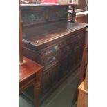 A late Victorian carved oak sideboard with Green Man details