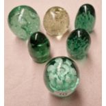 Six green glass Victorian paperweights