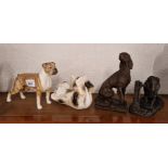A group of figures to include a Beswick boxer, Goebel cat and Heredities.