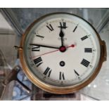 A Smiths brass bulkhead clock, 6" diameter dial.