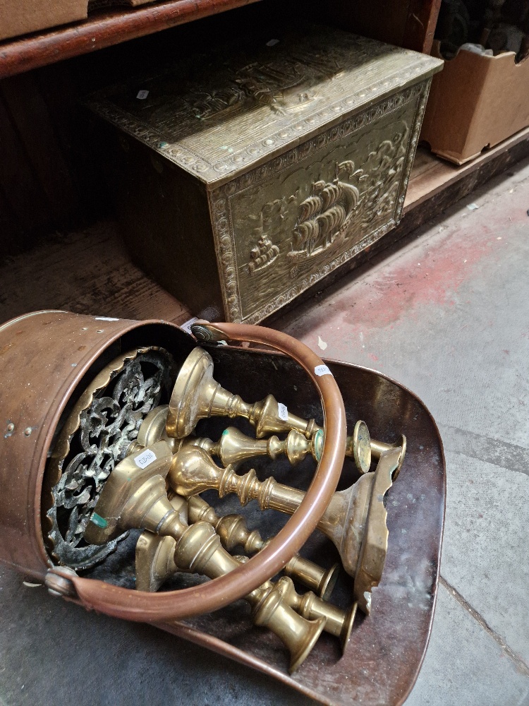 A mixed lot of copper and brass including, copper coal scuttle, brass candlesticks, trivet, etc.