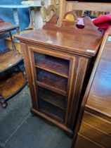 An Edwardian inlaid mahogany music cabinet.