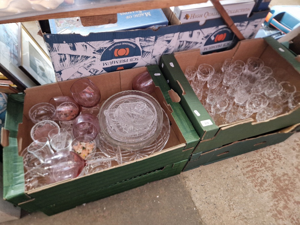 Four boxes of assorted glass.