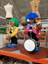 A pair of Christmas automatons modelled as clowns playing musical instruments.