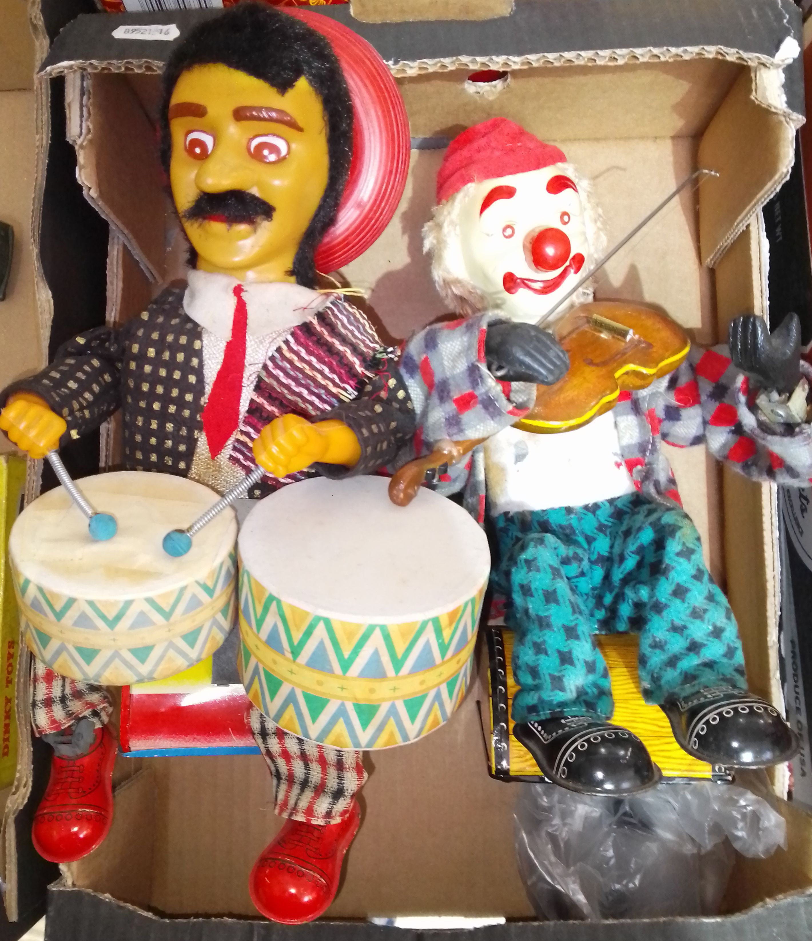 Two Japanese Alps mechanical tinplate toys comprising of a seated Mexican drummer & a seated clown