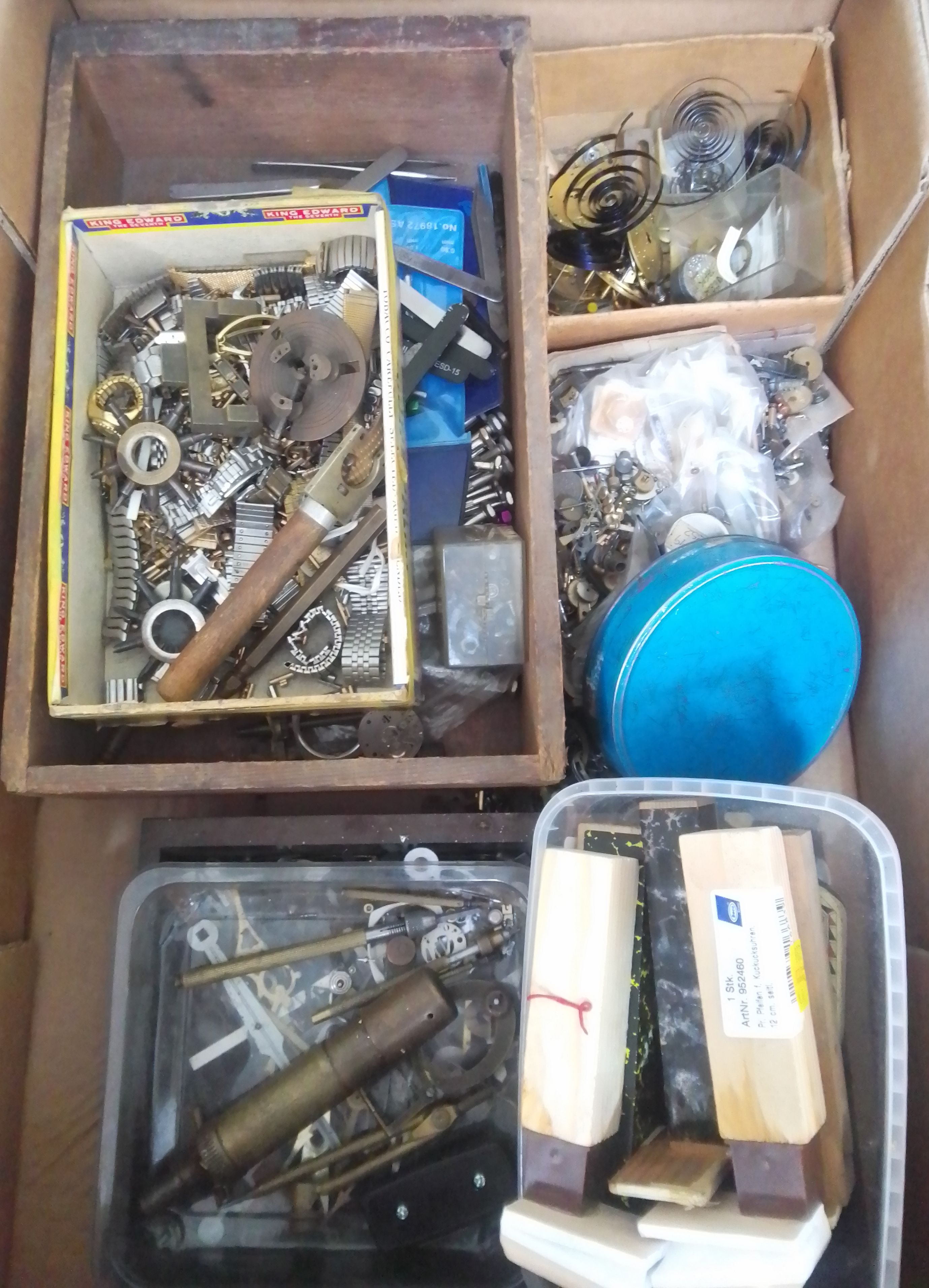 A box of mainly assorted horologist's spares and tools.