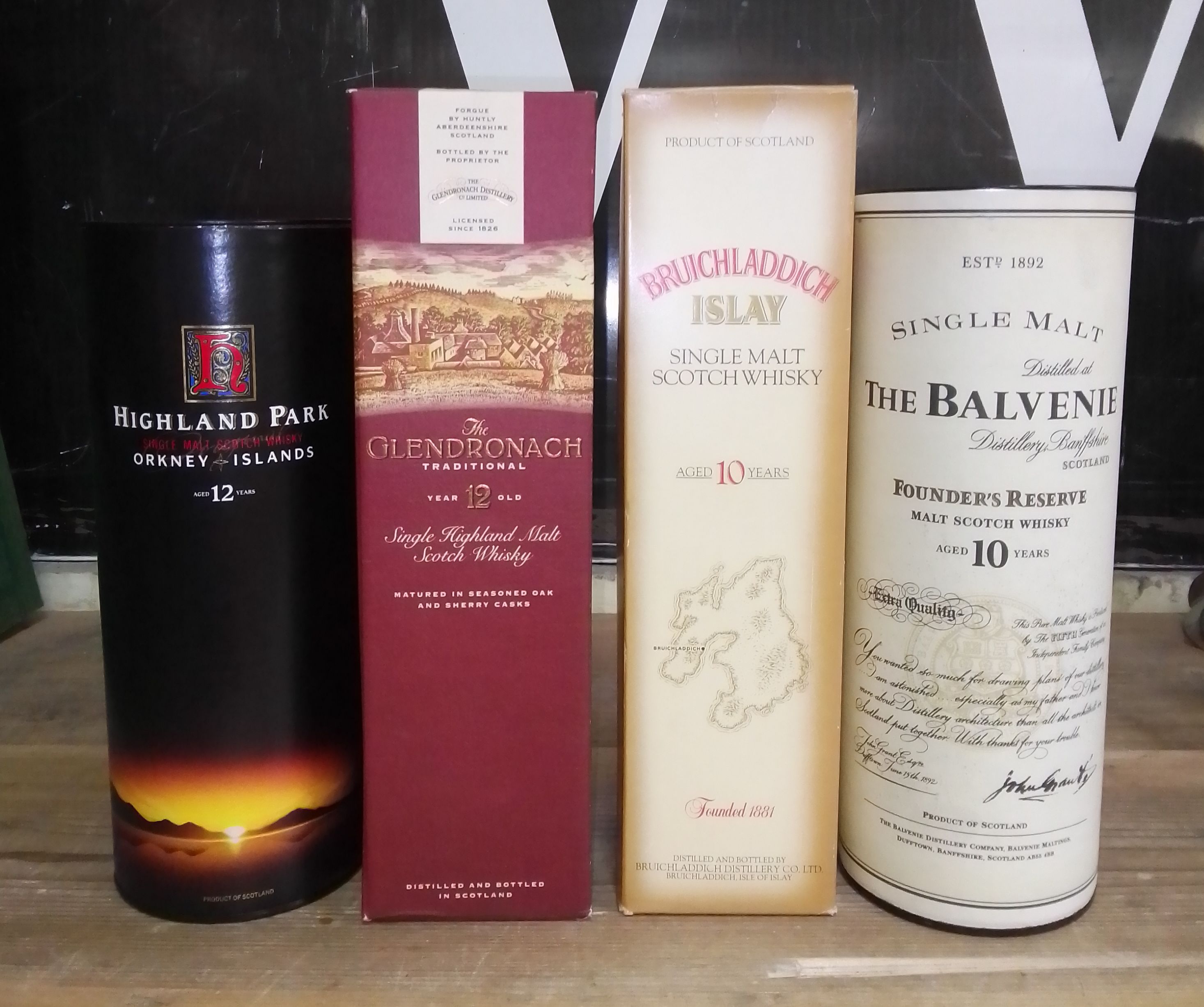 A group of four single malt scotch whiskies comprising Balvenie Founders Reserve, Bruichladdich,