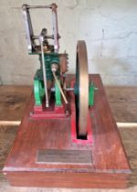 A well engineered model of a live steam trapezium stationary engine on wooden base, size of base
