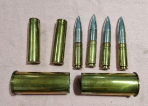 4 gun shells and 2 pairs of brass gun shell cases.