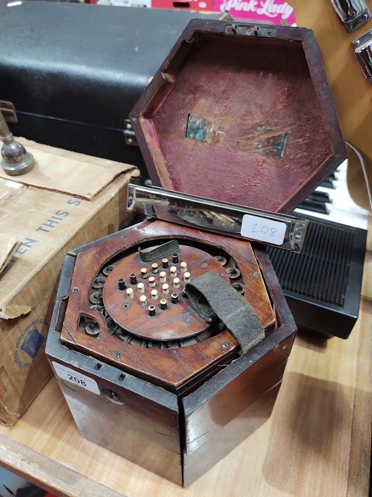 A Victorian concertina squeeze box, the mahogany case marked 'G F Wilson, London', together with a