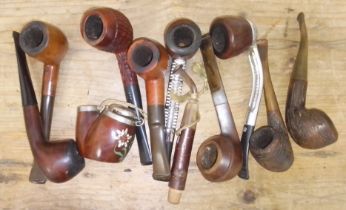 A box of assorted vintage old briar pipes.
