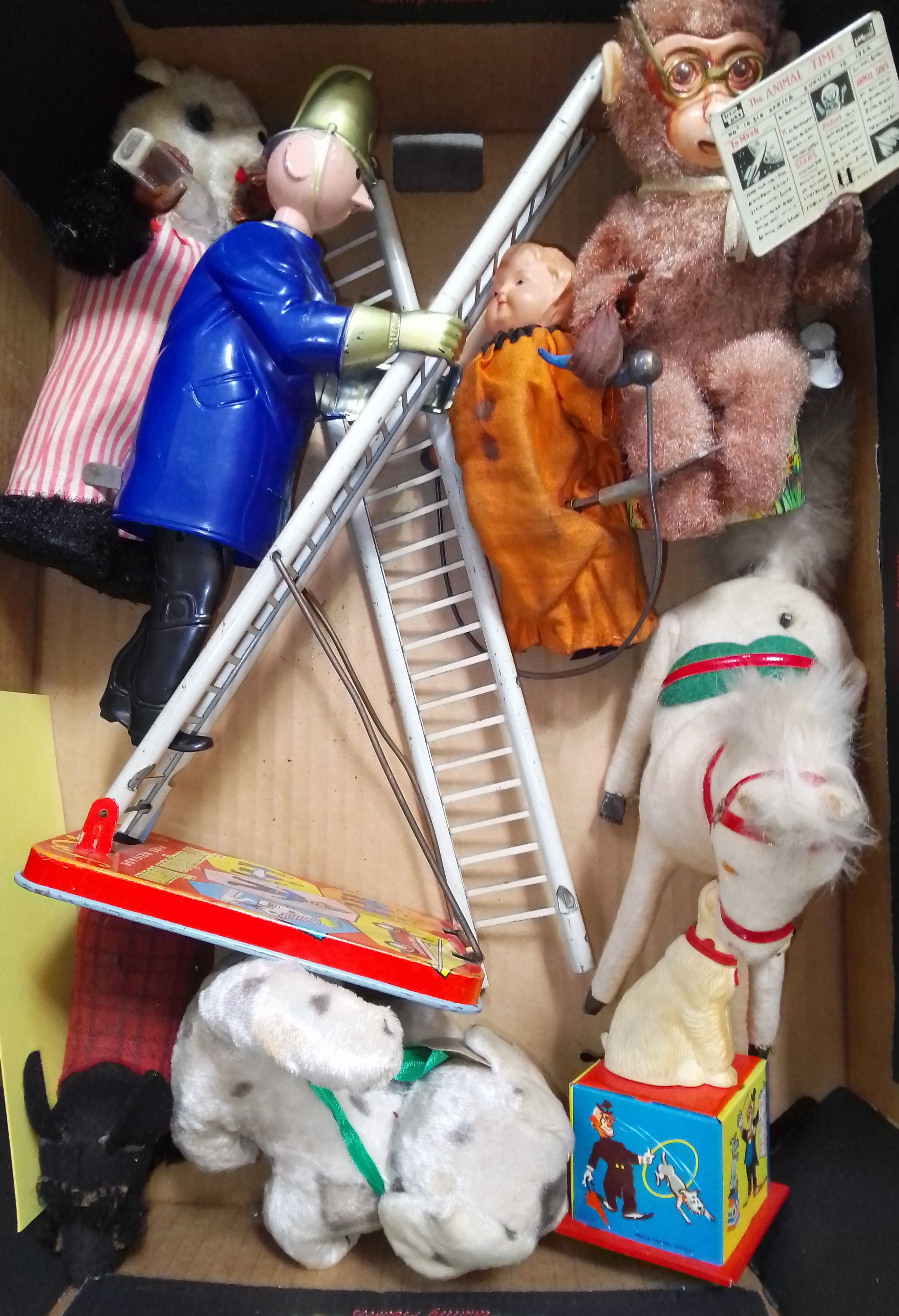 A group of eight wind up toys including a Trumpton Town fire man etc.
