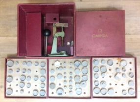 An Omega watch glass press, boxed with assorted dies.