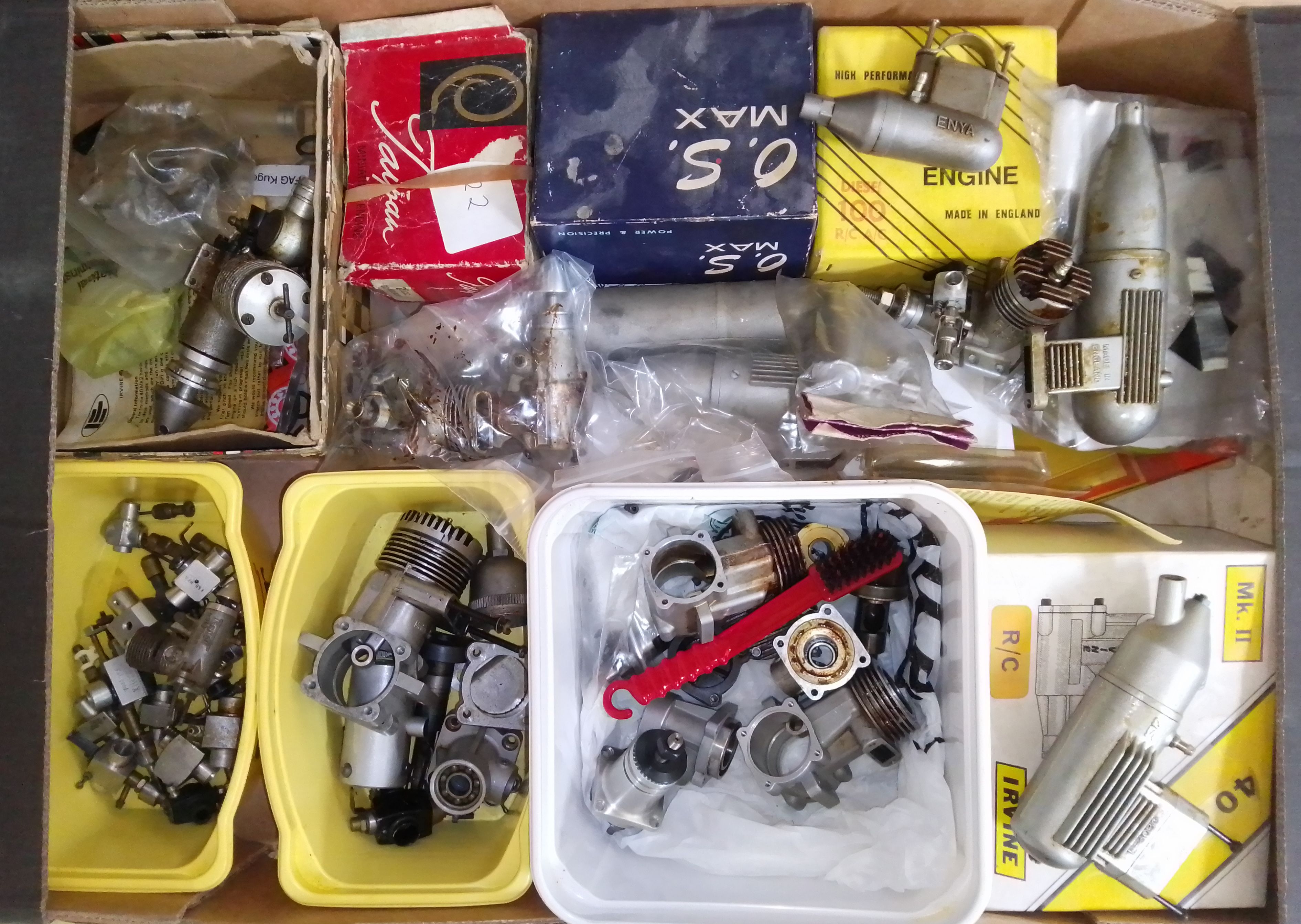 A box of assorted radio control aeroplane engines and parts