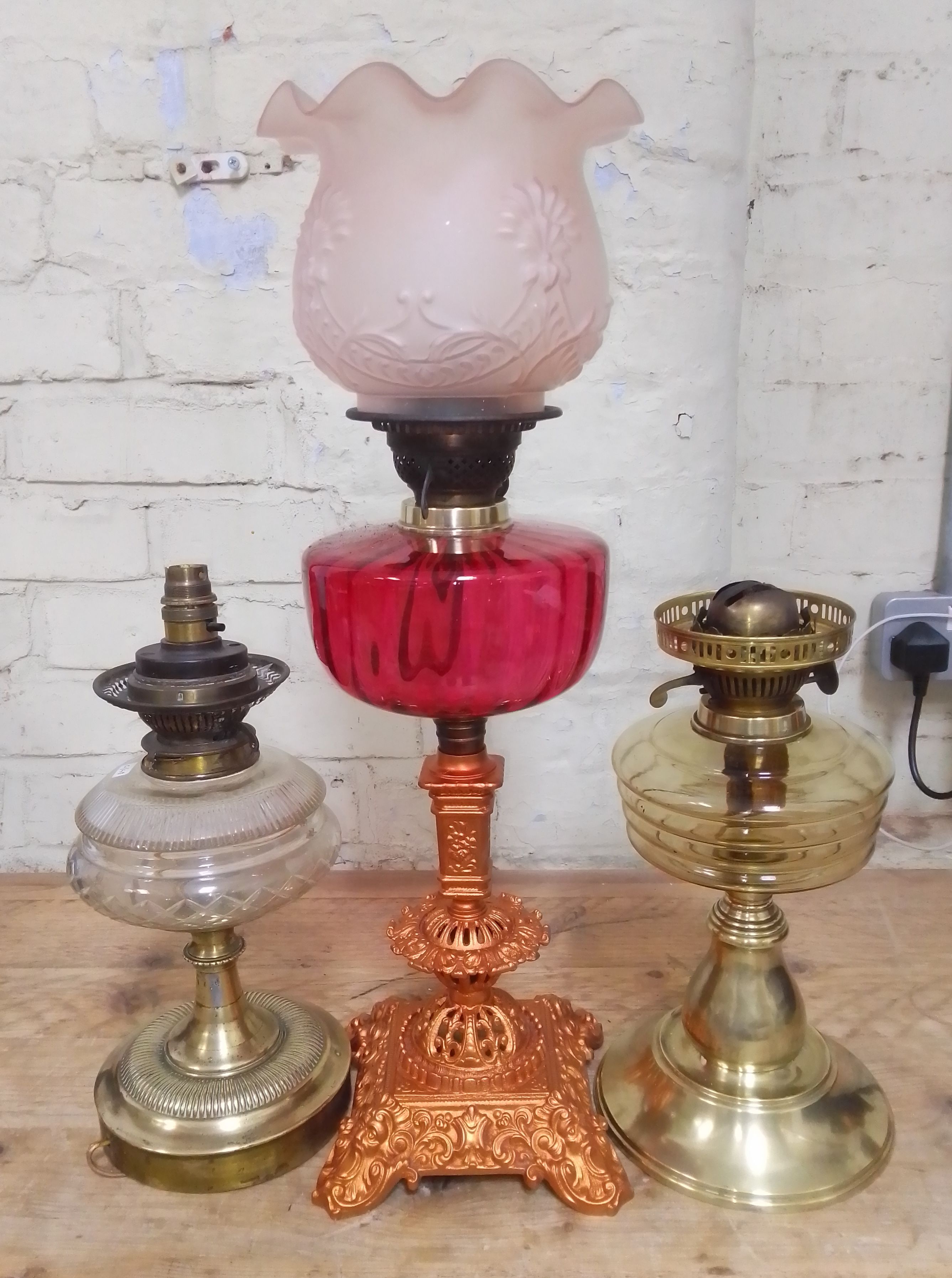 A group of three oil lamps.(one has been converted to electric)