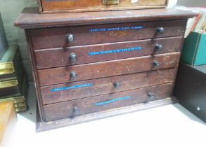 A horologist's five drawer chest and contents comprising watch and clock making spares.
