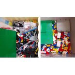Two boxes of loose Lego with various instruction manuals.