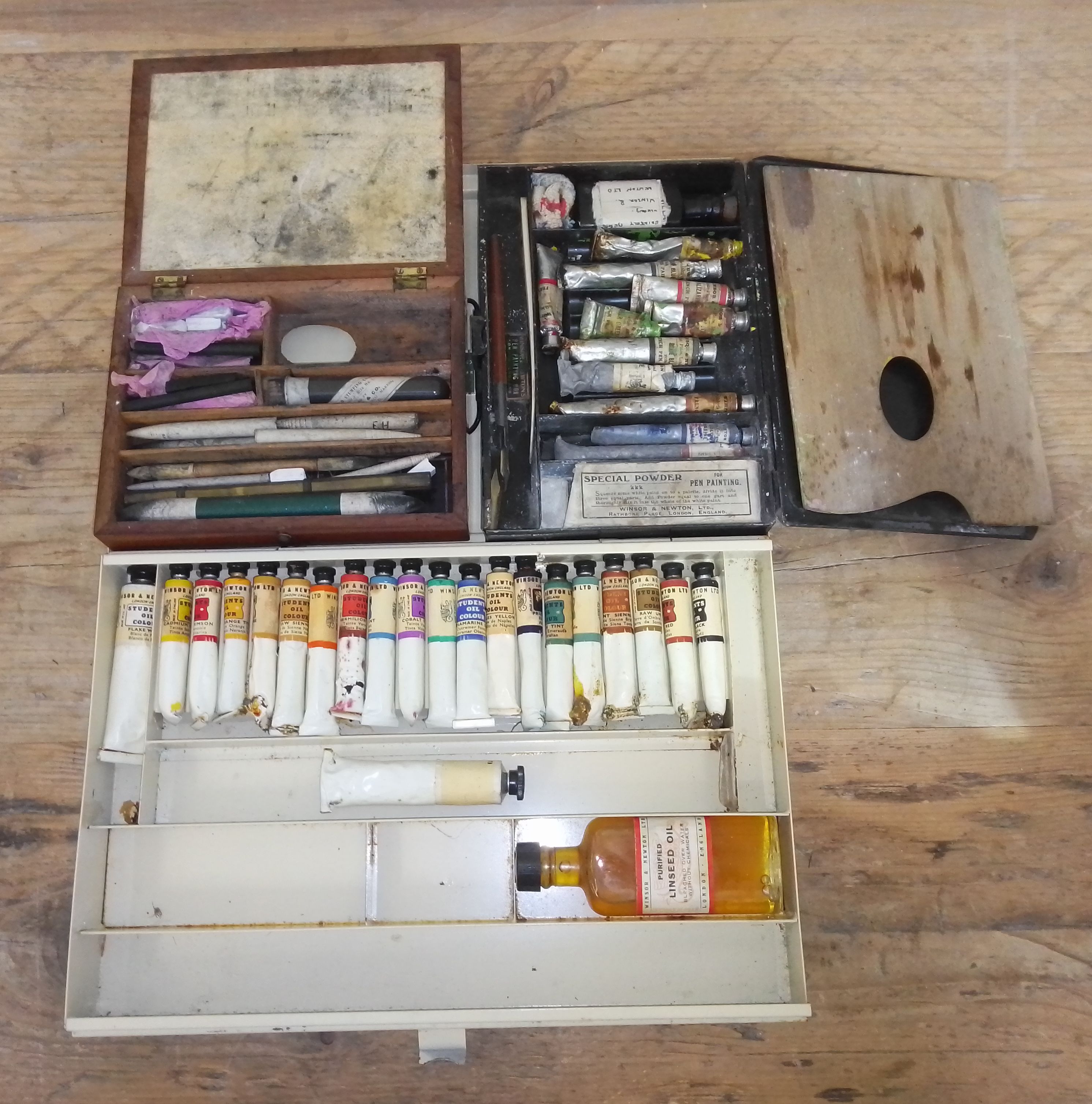 A group of three artist's paint tins and contents.