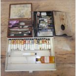 A group of three artist's paint tins and contents.