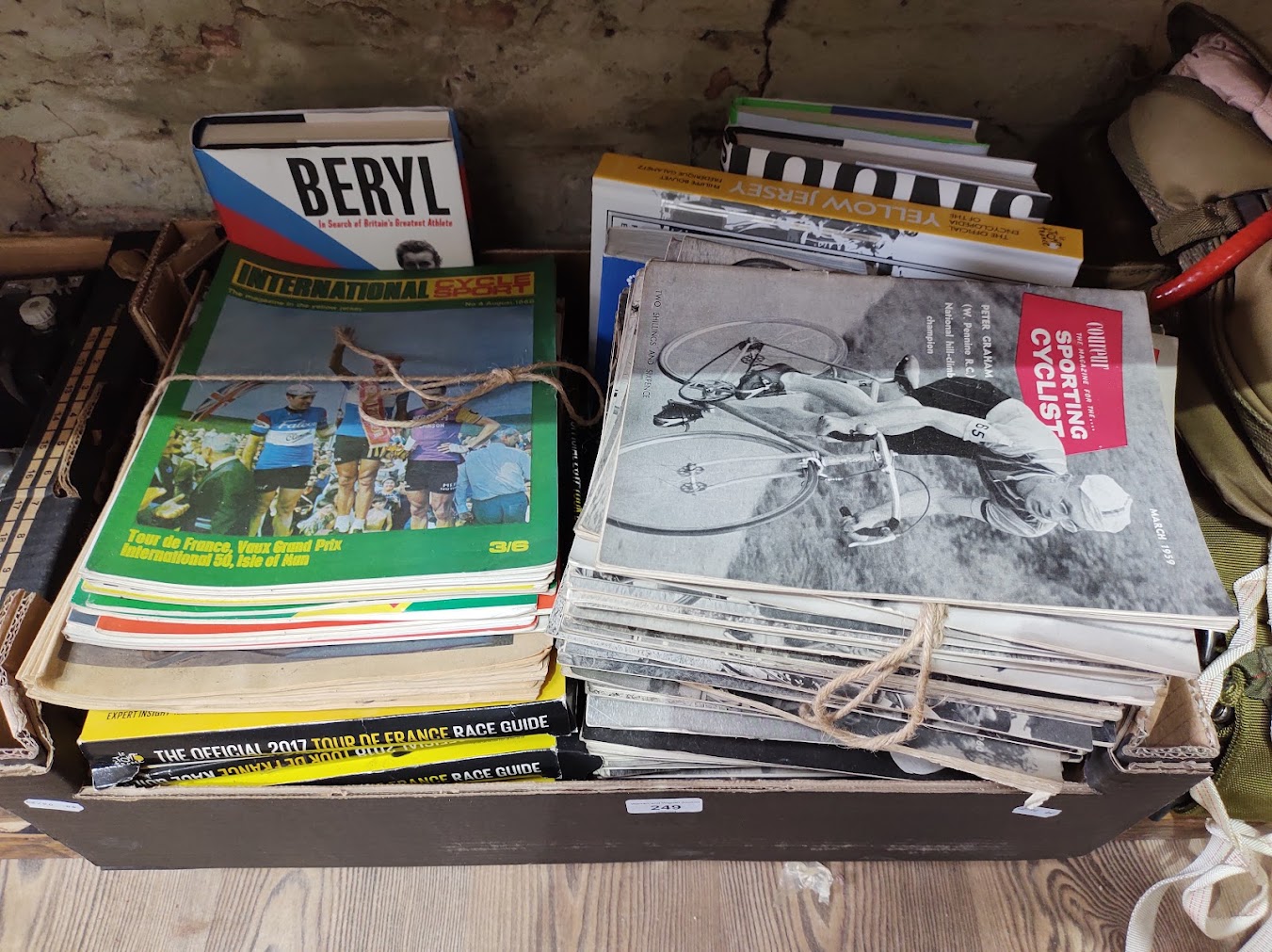 A box of assorted cycling ephemera including 1960s Coureur magazines, 1960s International Cycle