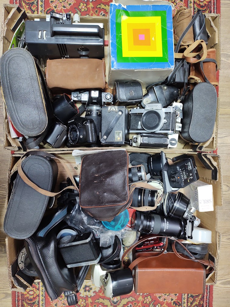 Two boxes of cameras, binoculars and accessories including Nikon, Pentax & Praktica 35mm cameras,