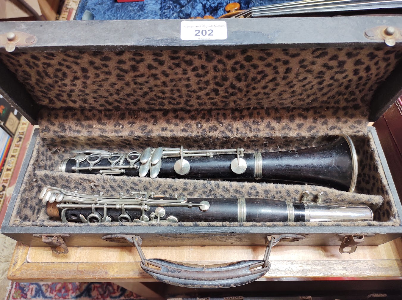 A rosewood clarinet marked 'France' and 'New Brunswick'.