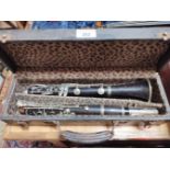 A rosewood clarinet marked 'France' and 'New Brunswick'.