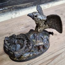 A 19th century cast iron mechanical money bank, modelled as an eagle feeding its young, impressed