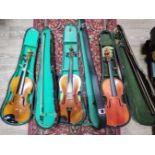 Three Chinese Skylark student violins, each with bow and hard case.