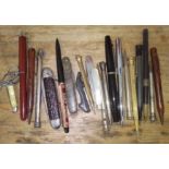 A collection of assorted pens, pencils and penknives.