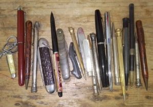 A collection of assorted pens, pencils and penknives.