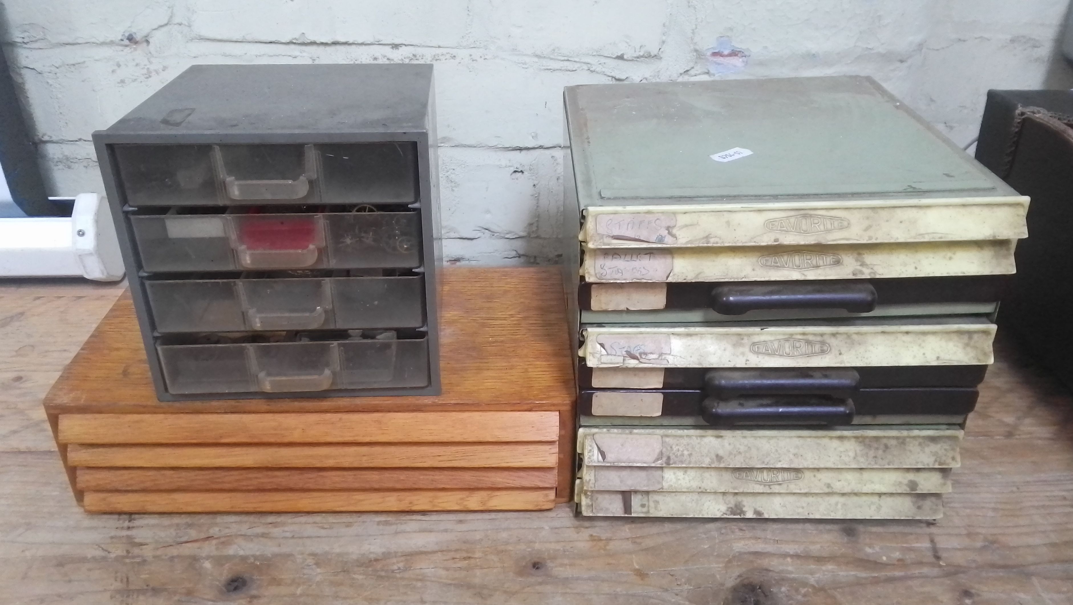 Wooden, plastic and metal cabinets of watch spares.