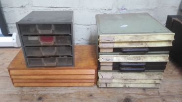 Wooden, plastic and metal cabinets of watch spares.
